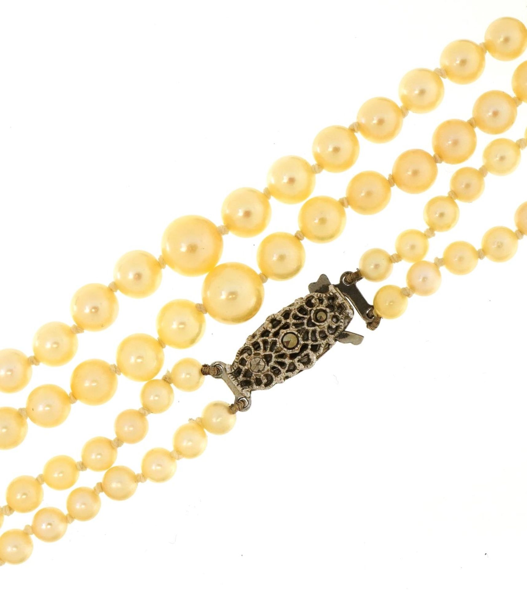 Graduated cultured pearl two string necklace with silver marcasite clasp and box, 44cm in length,