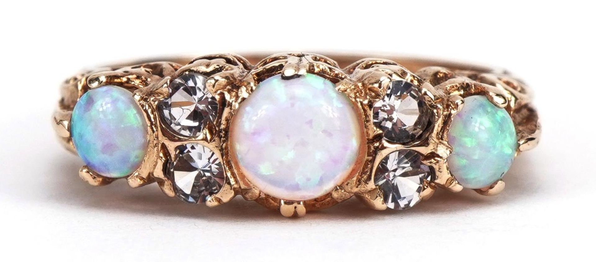 Victorian style 9ct gold clear stone and cabochon opal seven stone ring housed in a Chas