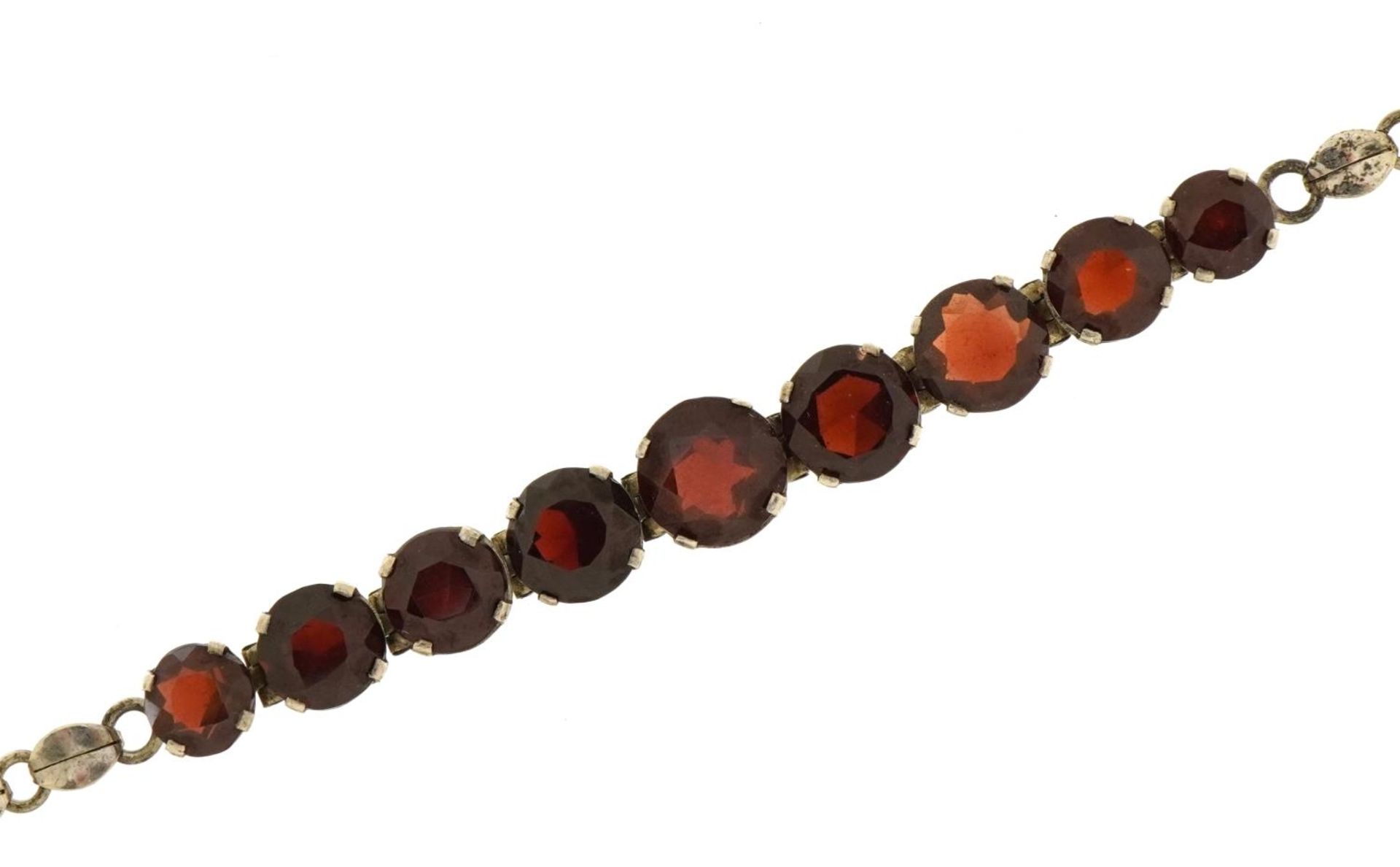 Antique unmarked silver bracelet set with nine garnets, 18.5cm in length, 8.6g