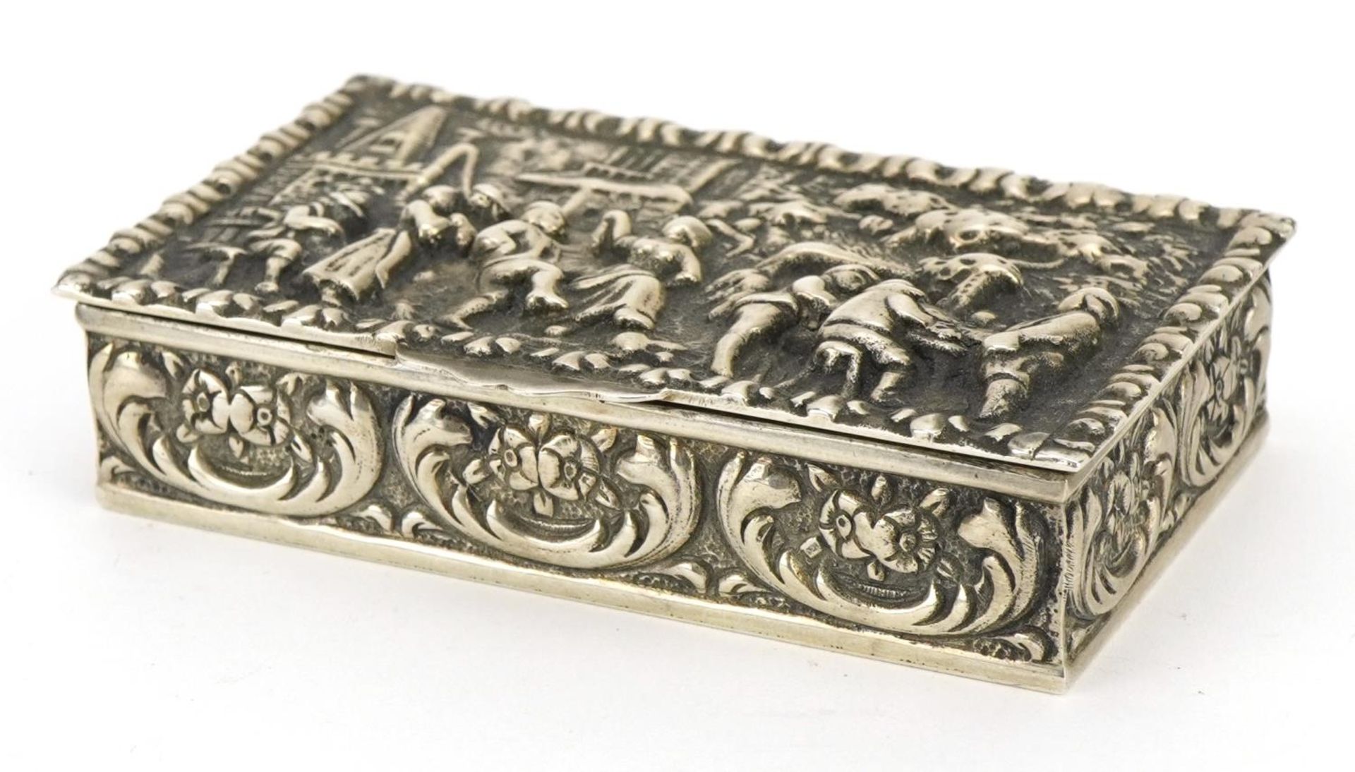 Dutch silver snuff box, the hinged lid embossed with merry figures, impressed marks to the base, 8cm