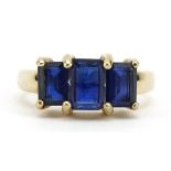 9ct gold blue stone trilogy ring, tests as sapphire, the largest stone approximately 6.8mm x 5.
