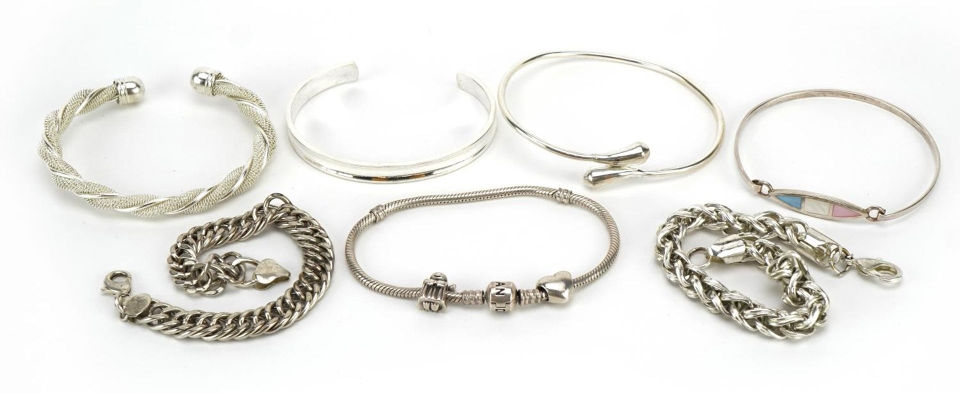 Five silver bangles and bracelets and two white metal bracelets including Pandora, total weighable