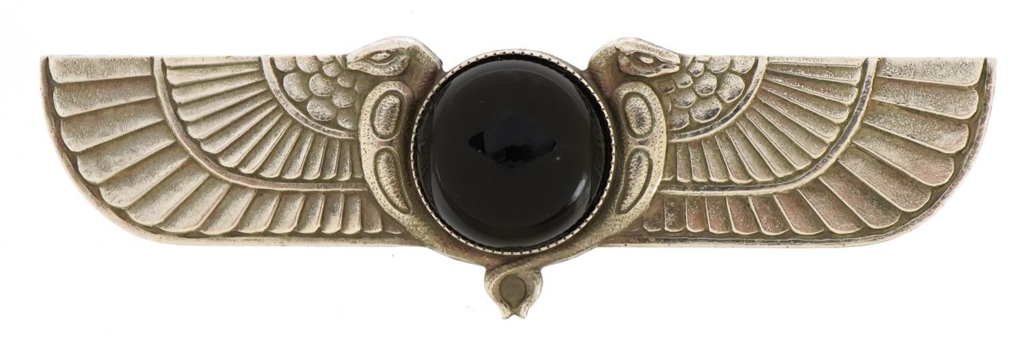 Egyptian Revival white metal brooch set with a cabochon black stone, 8cm wide, 22.5g