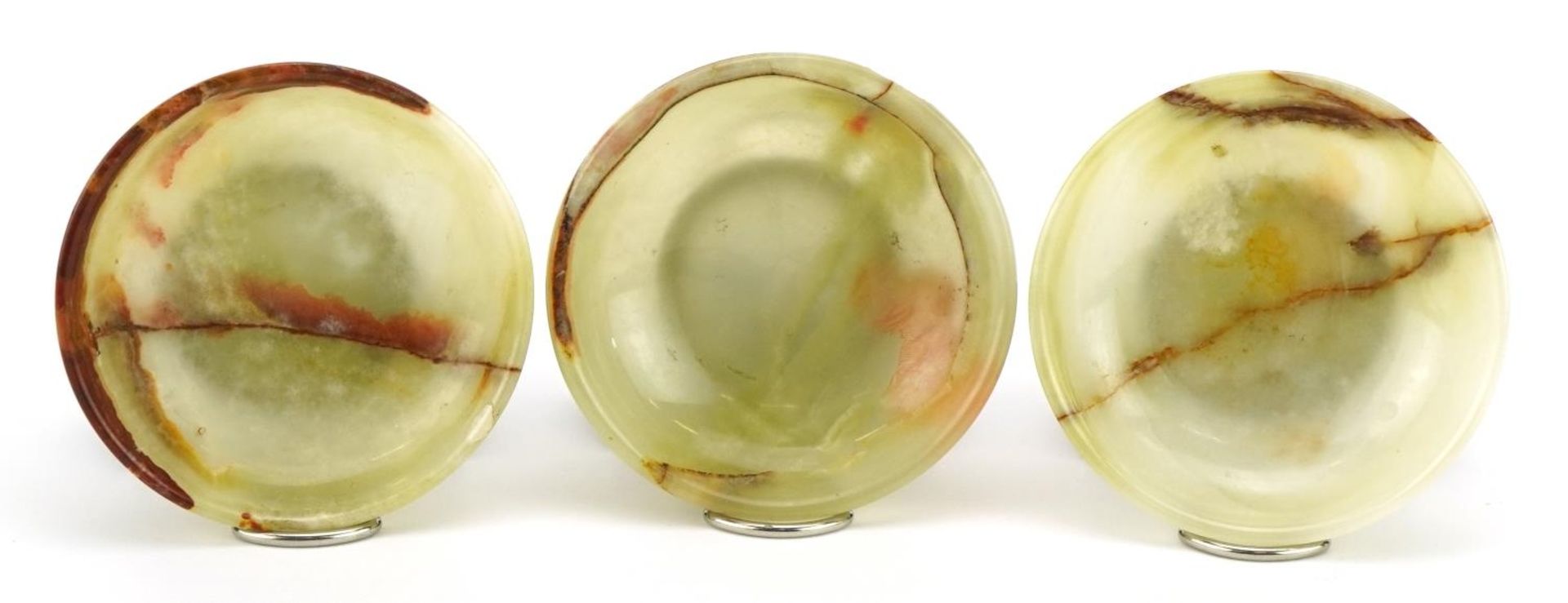 Three 800 grade silver mounted onyx footed dishes, each 6.5cm in diameter