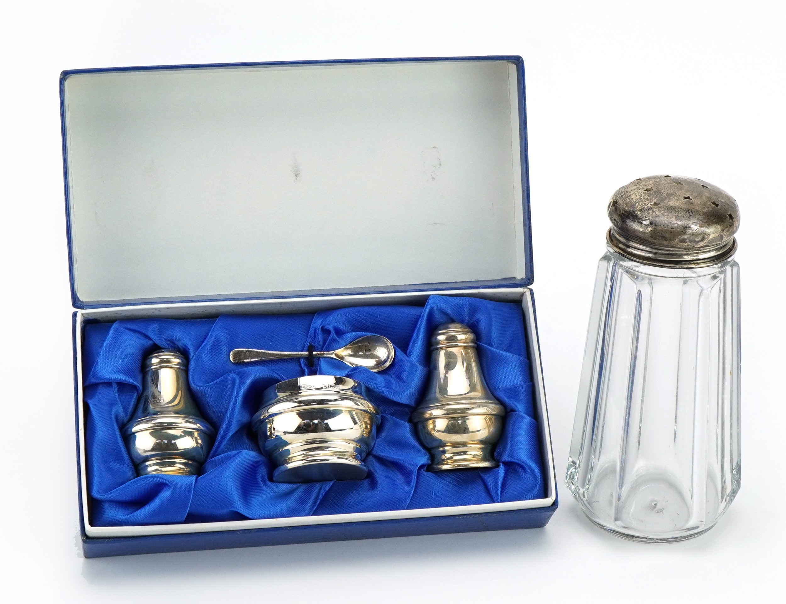 Silver three piece cruet set with fitted box and a cut glass sifter with silver lid, the cruet set