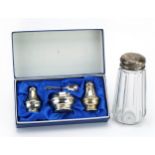 Silver three piece cruet set with fitted box and a cut glass sifter with silver lid, the cruet set