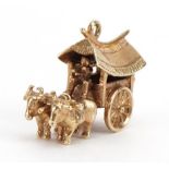 9ct gold Asian cart and buffalo charm, 2.3cm wide, 4.9g