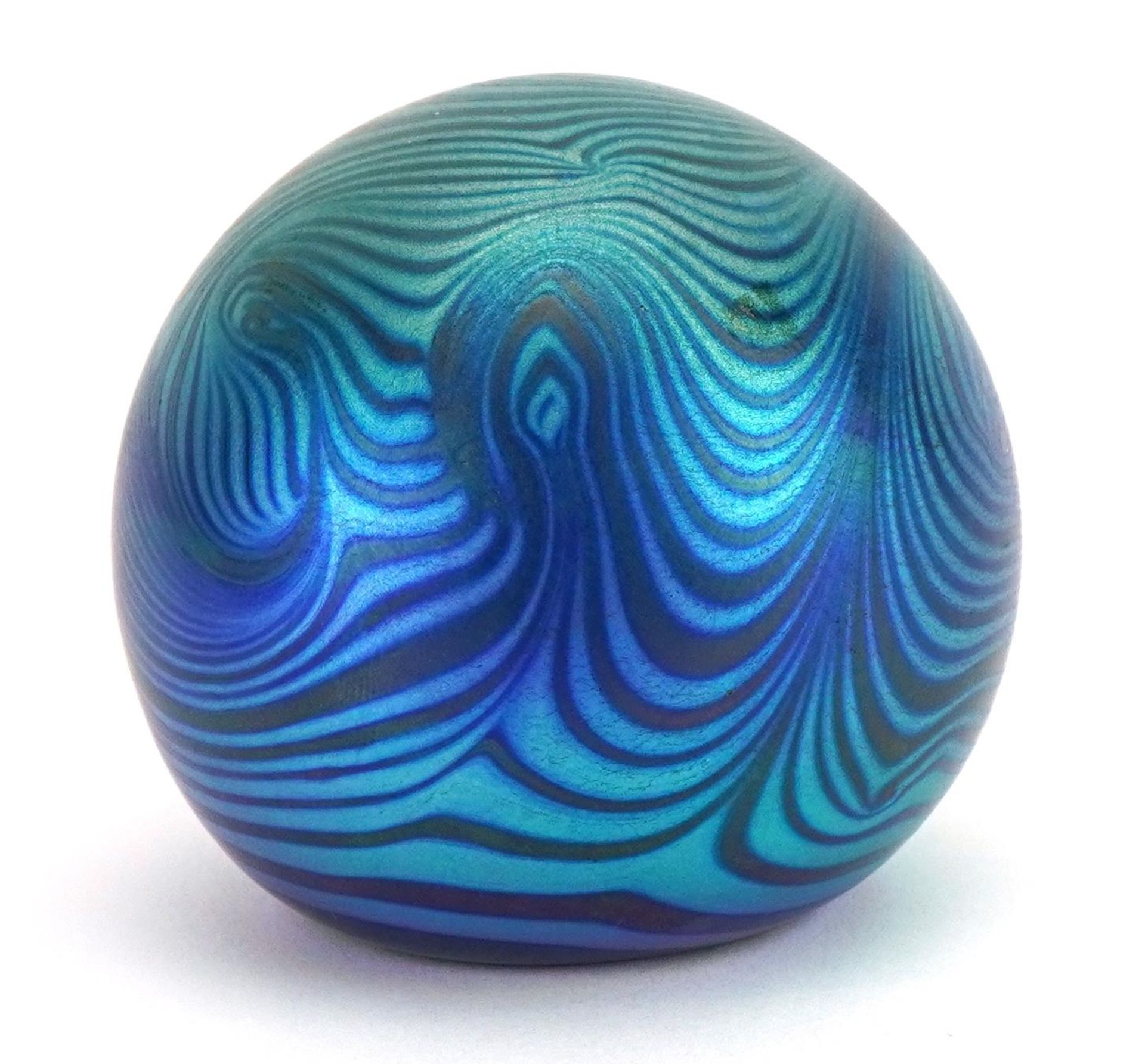 Iridescent art glass paperweight with combed decoration, etched marks to the base, 6.5cm high