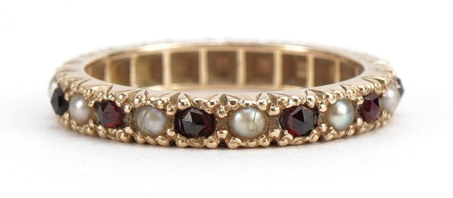 9ct gold garnet and seed pearl eternity ring, size J, 2.2g