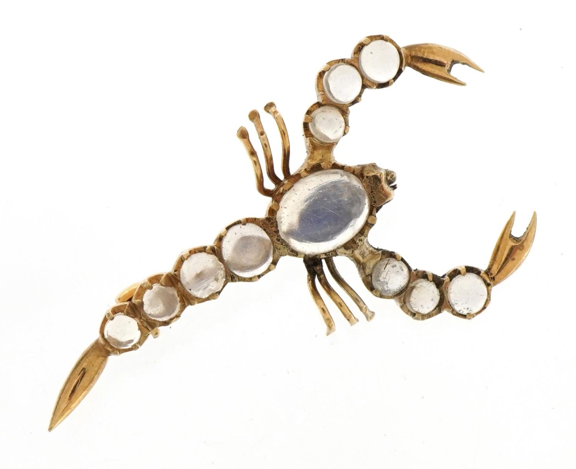 Unmarked gold cabochon moonstone scorpion brooch, 4.6cm wide, 3.4g