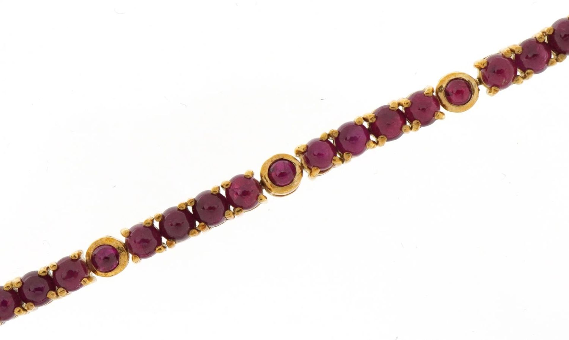 9ct gold cabochon ruby line bracelet, 19.5cm in length, 11.3g