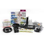Black Nintendo Wii and Nintendo Wii U games consoles with controllers, accessories and a