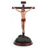 Frankin Mint porcelain model of Christ raised on a circular wood stand titled The Crucifixion,