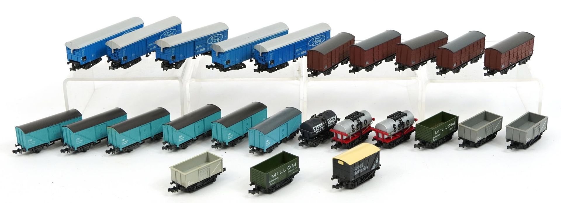 Twenty five N gauge model railway wagons and tankers including Peco and Trix, housed in two