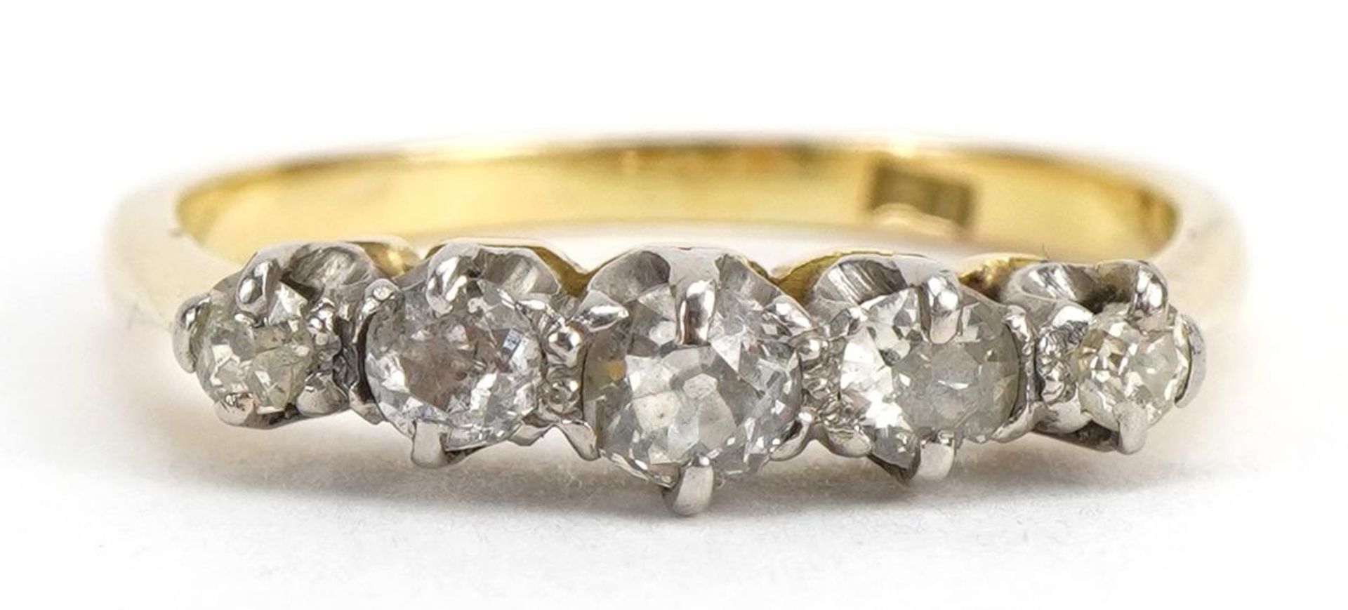 18ct gold diamond five stone ring, the largest diamond approximately 3.1mm in diameter, size M/N,