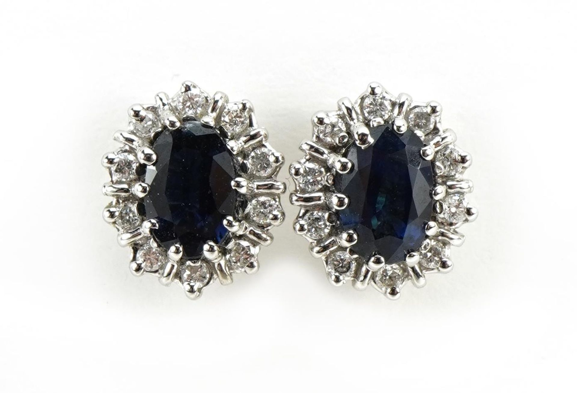 Pair of 18ct gold sapphire and diamond cluster stud earrings, 2.4g