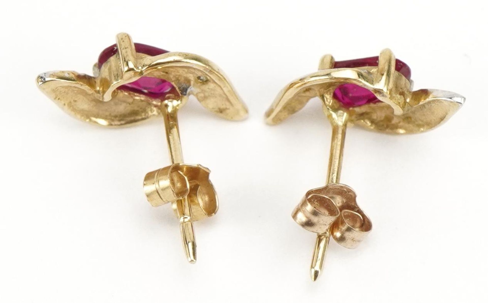 Pair of unmarked gold ruby and diamond crossover stud earrings, 1.2cm high, 0.9g - Image 2 of 2