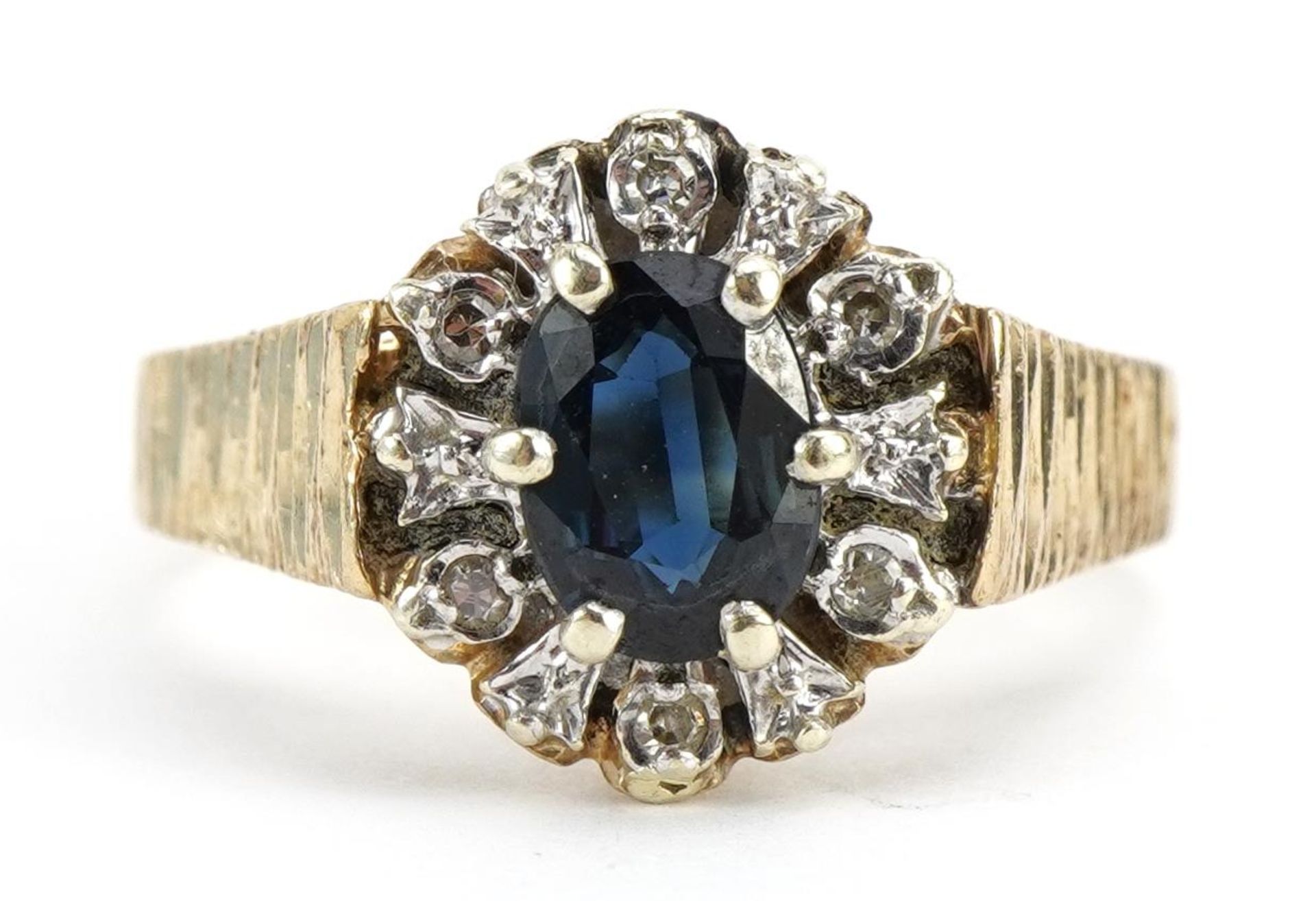 9ct gold sapphire and diamond cluster ring with bark design shoulders, size N, 3.1g