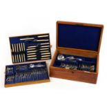 Racine oak canteen of silver plated cutlery, the knives and carving set with ivorine handles, the
