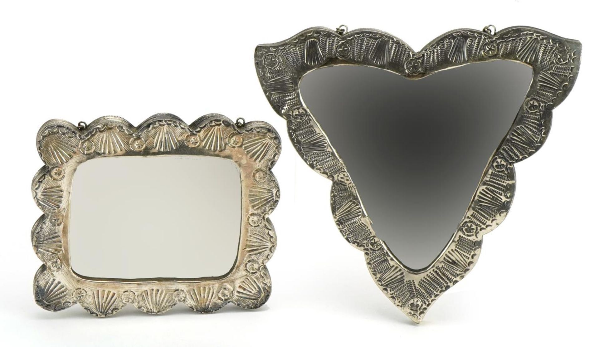 Two Turkish 900 grade silver backed mirrors embossed with flowers, the largest 16.5cm wide