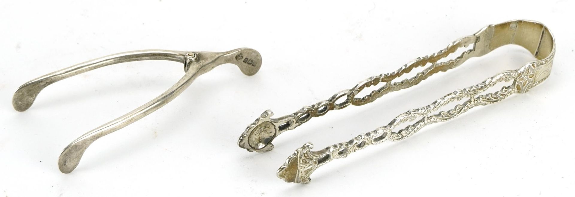 Pair of Georgian silver sugar tongs engraved 1779 and a pair of George V silver sugar nips in the