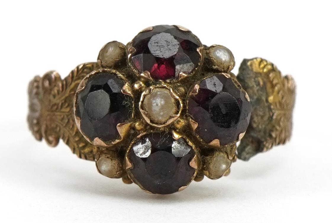 Victorian 9ct gold garnet and seed pearl cluster mourning ring with scrolled shoulders, Birmingham