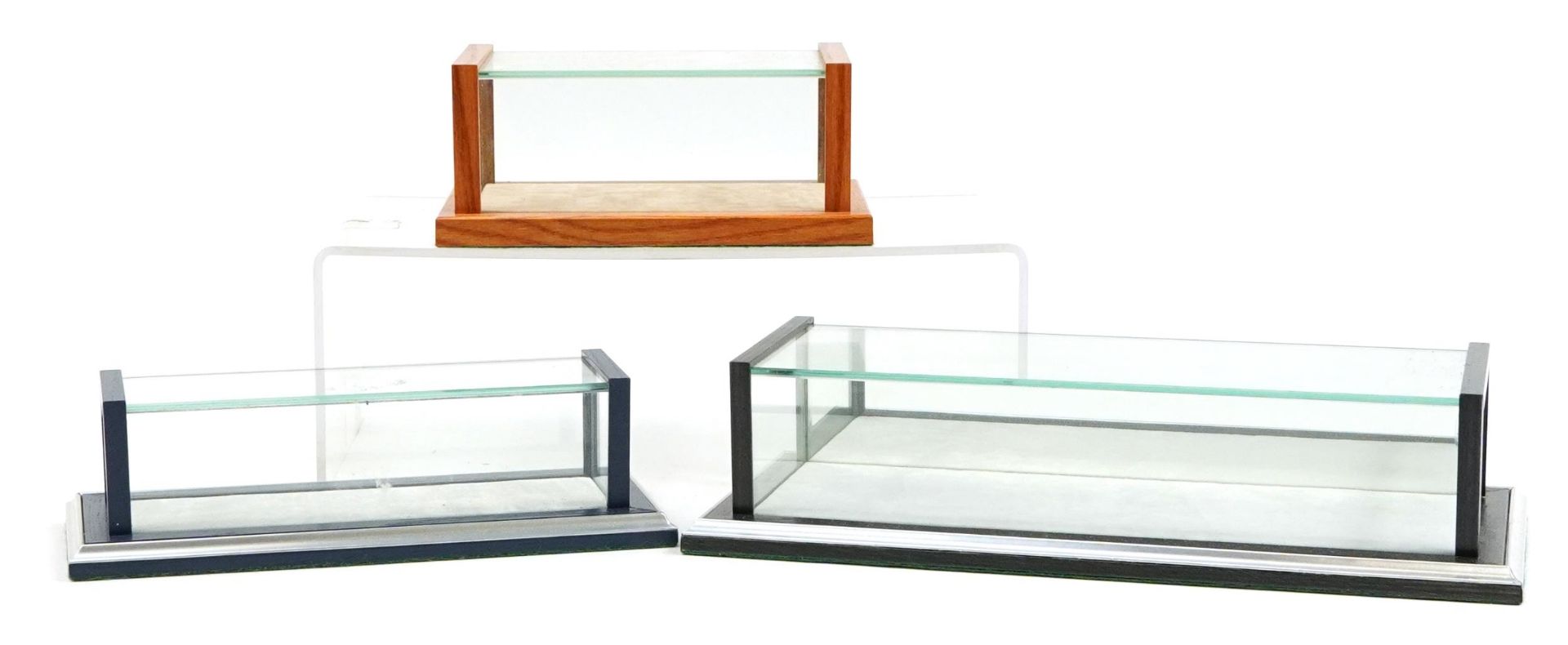 Three wooden and glass collector's model display cases, the largest 32cm in length