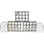 Three vintage twelve bottle wine racks and a pair of stainless steel five bottle wine racks, the