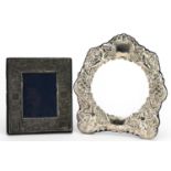 Two silver mounted photo frames comprising one christening photo frame and one other embossed with