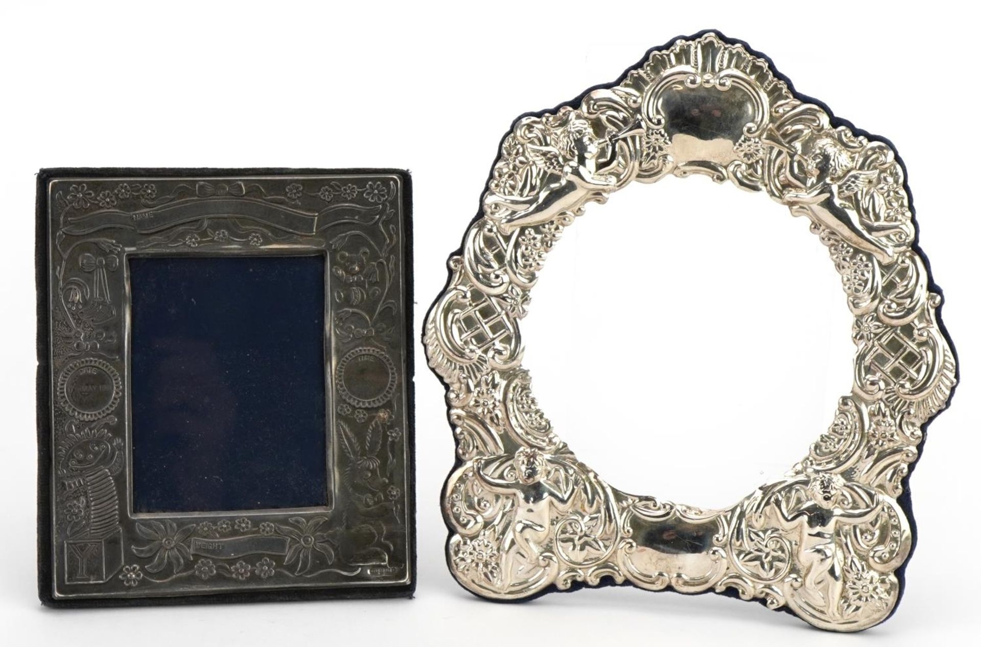 Two silver mounted photo frames comprising one christening photo frame and one other embossed with