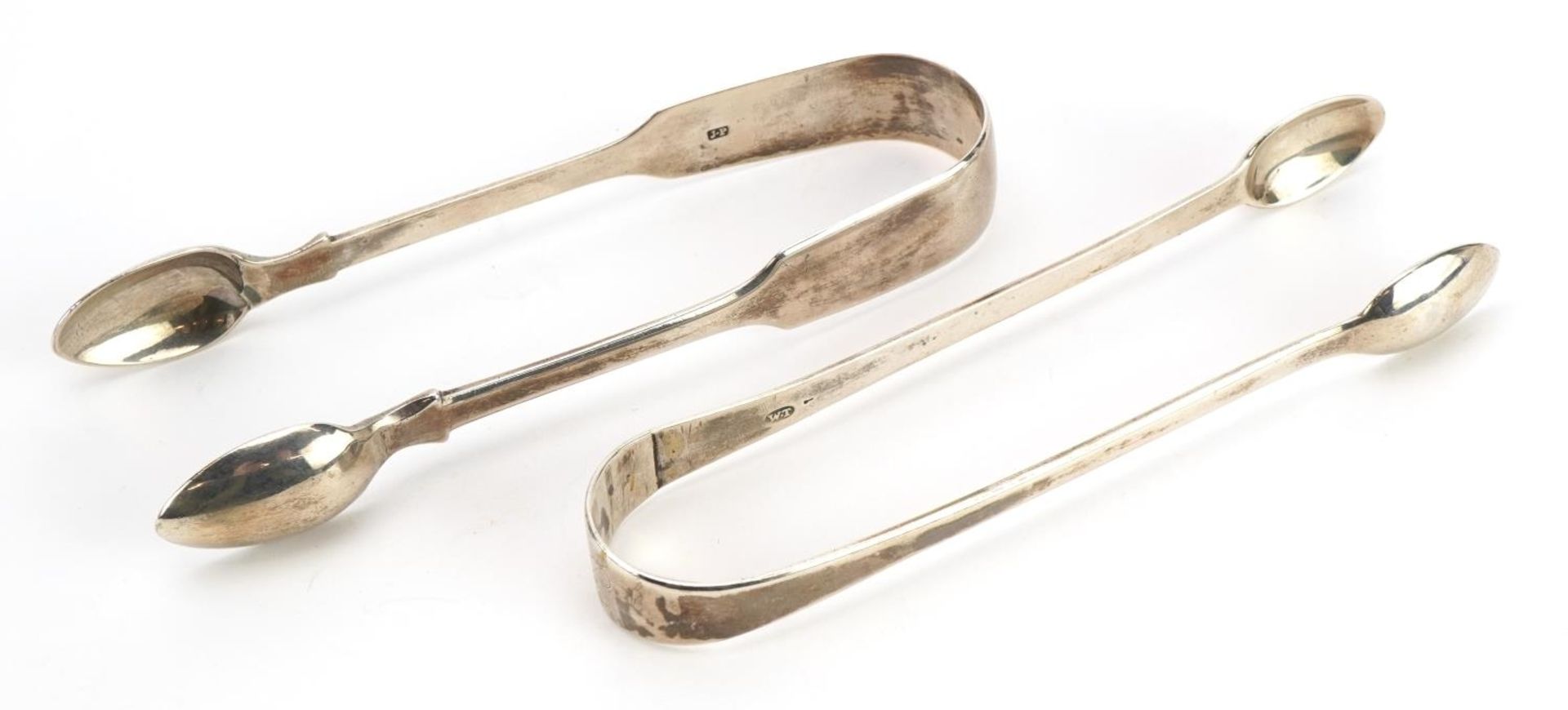 Two Georgian silver sugar tongs including a George IV example, William M Traies, London 1825, the