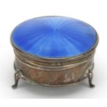 George V circular silver and blue guilloche enamel jewel box with hinged lid, raised on three