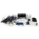 Two PlayStation 2 games consoles and a Nintendo Wii games console with controllers and accessories