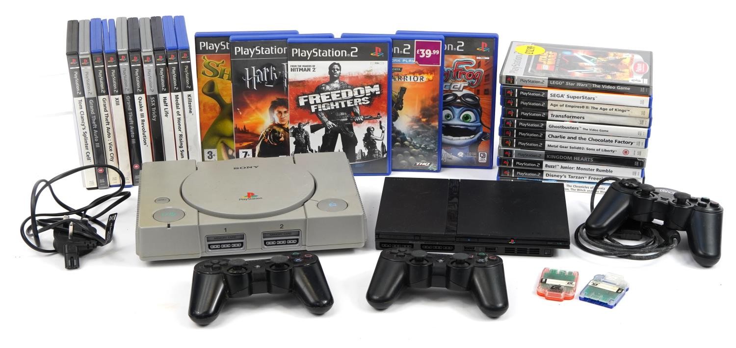 PlayStation 1 and PlayStation 2 Slimline games consoles with controllers and a collection of games