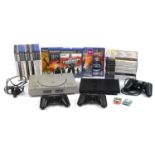 PlayStation 1 and PlayStation 2 Slimline games consoles with controllers and a collection of games