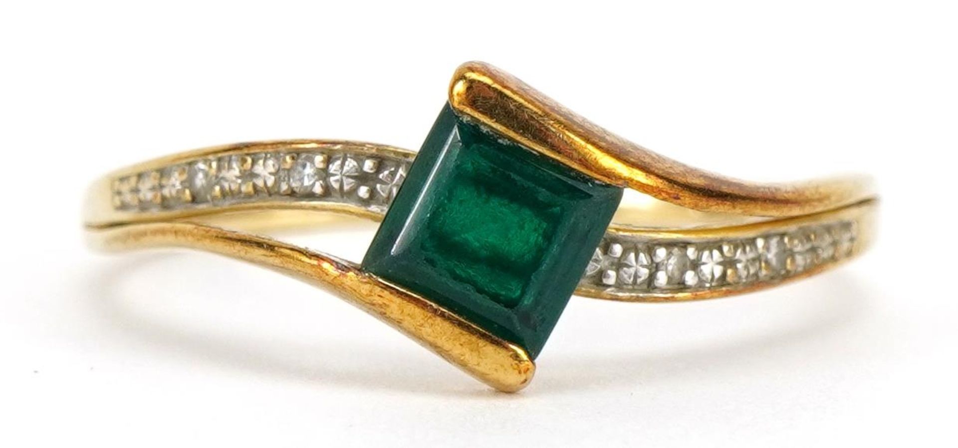 9ct gold emerald and diamond crossover ring, the emerald approximately 5.1mm wide, size T, 1.8g