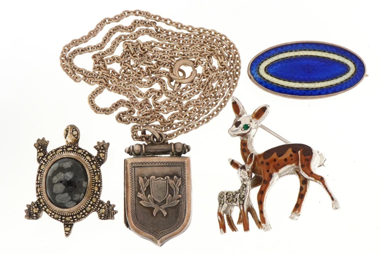 Silver and white metal jewellery including shield design locket, enamelled brooch and a marcasite