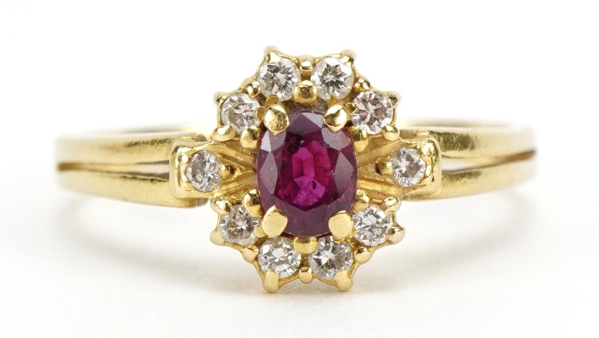 18ct gold ruby and diamond cluster ring, the ruby approximately 5.0mm x 3.9mm, size S/T, 4.0g