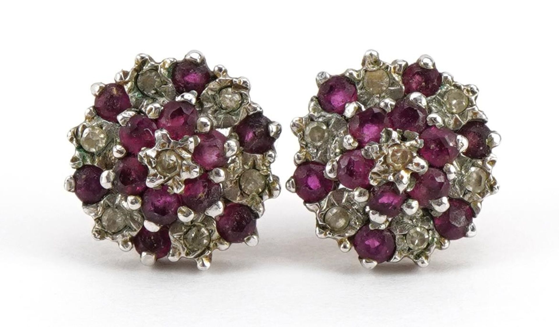 Pair of 9ct gold diamond and ruby three tier cluster stud earrings, 9mm in diameter, 1.6g