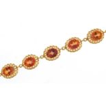 9ct gold iridescent orange/pink stone bracelet, 20cm in length, 22.1g