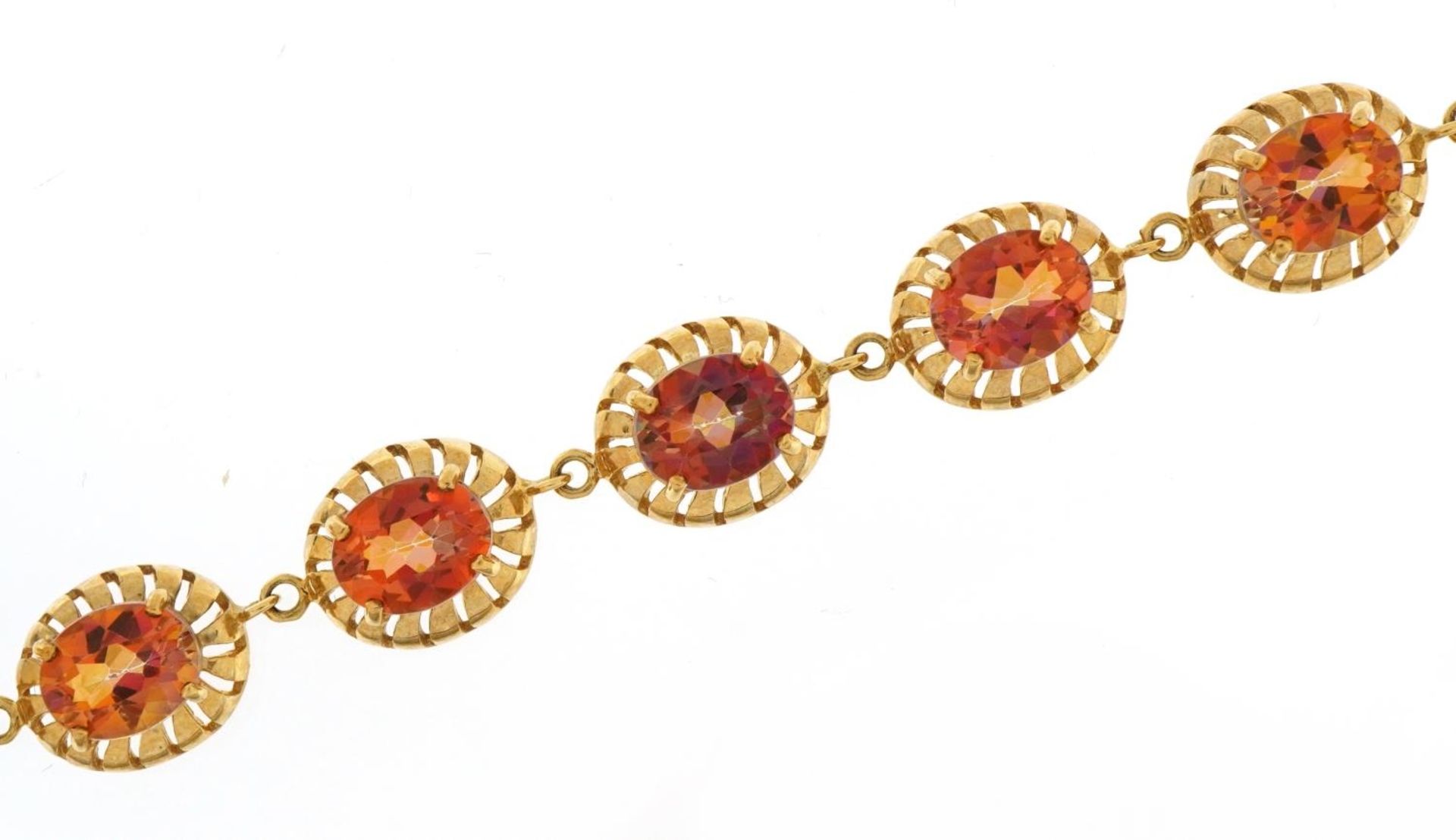 9ct gold iridescent orange/pink stone bracelet, 20cm in length, 22.1g