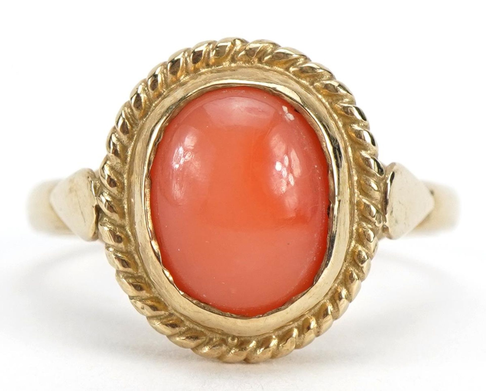 9ct gold cabochon coral solitaire ring, the stone approximately 9mm x 6.9mm, size P, 3.6g