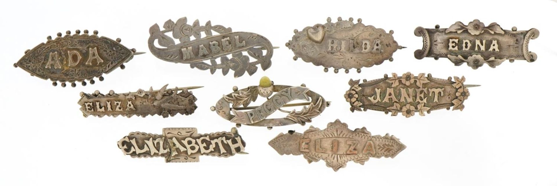 Nine Victorian silver name brooches including Mabel, Eliza and Hilda, the largest 4.3cm wide,