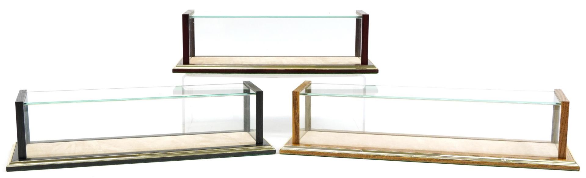 Three wooden and glass collector's model display cases, the largest 43cm in length