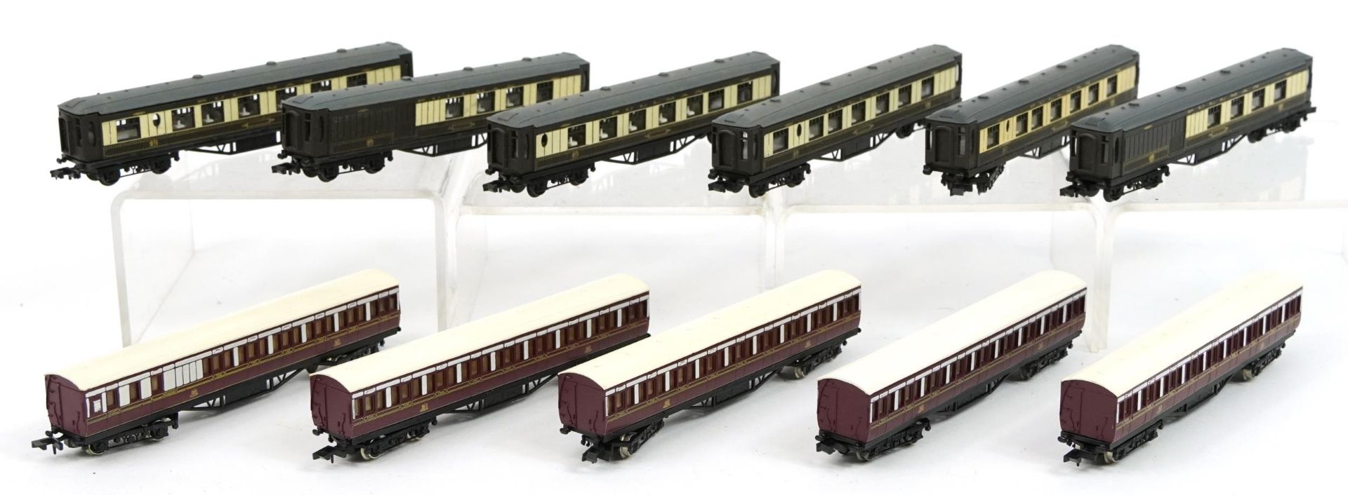 Eleven N gauge model railway carriages housed in two protective cases