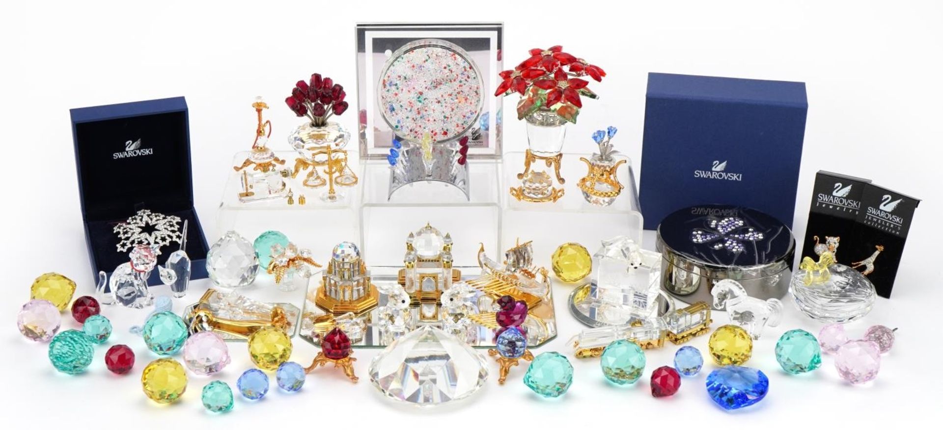 Collection of mostly Swarovski Crystal including miniature flowers raised on a stand, snowflake