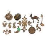 Collection of silver and white metal charms and pendants including a Pickelhaube helmet, crucifix