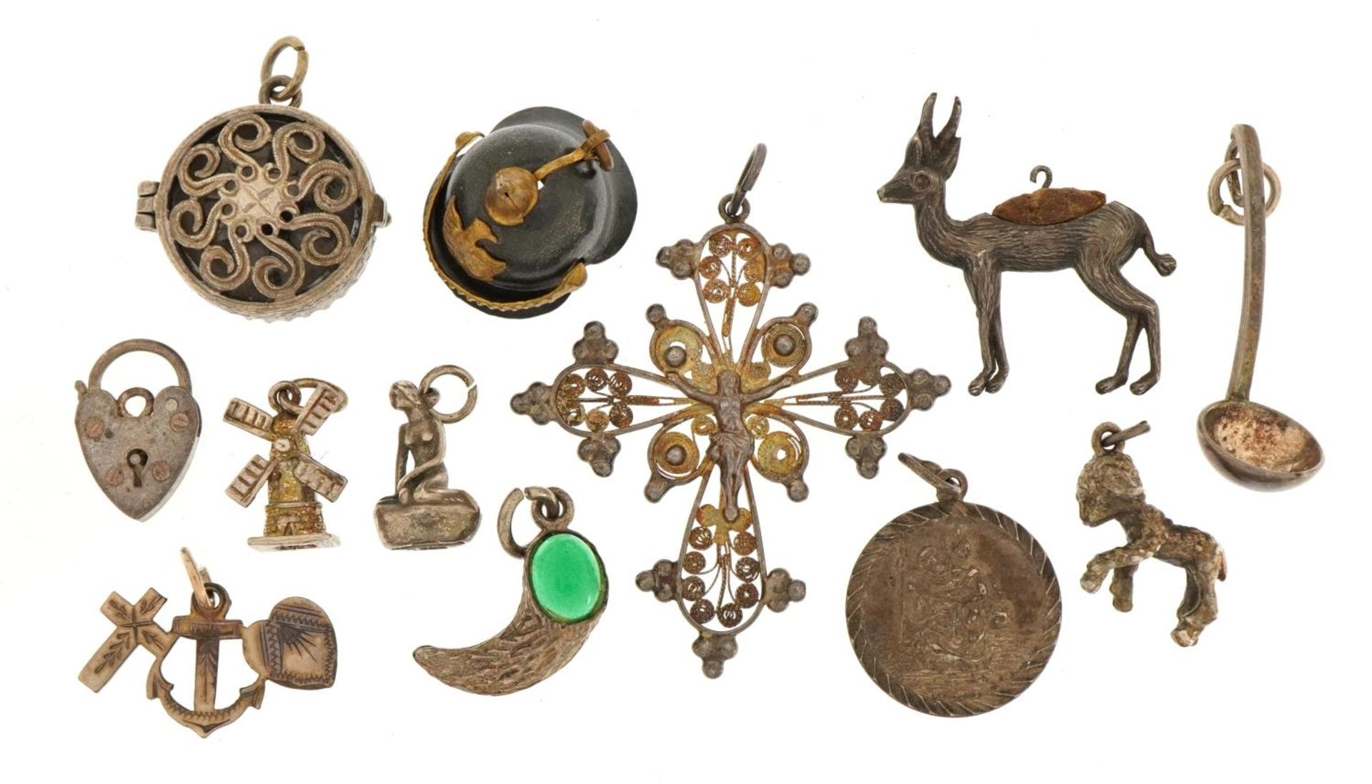 Collection of silver and white metal charms and pendants including a Pickelhaube helmet, crucifix