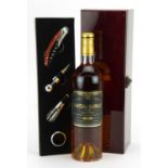 Bottle of 1998 Chateau Guiraud 1er Cru Sauternes dessert wine with presentation box and accessories