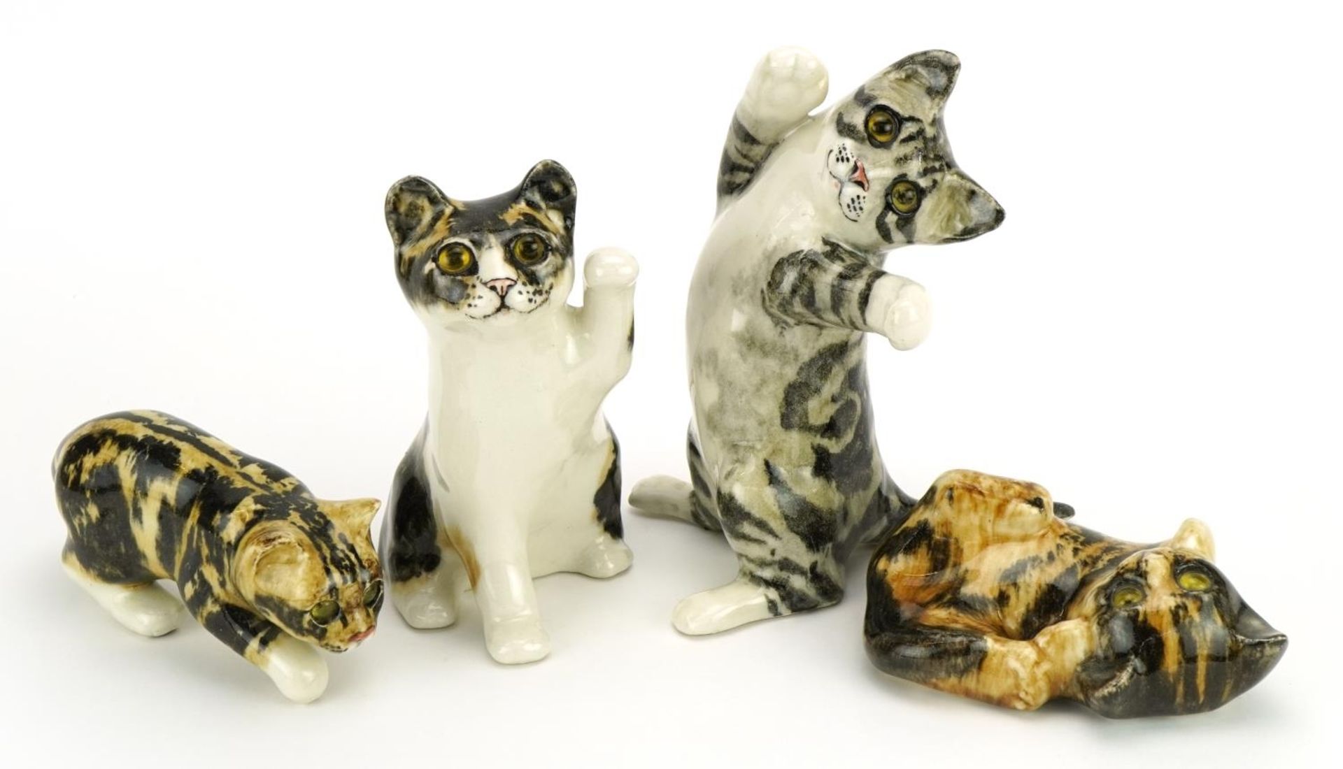 Four Winstanley pottery cats with beaded eyes, the largest 25cm high